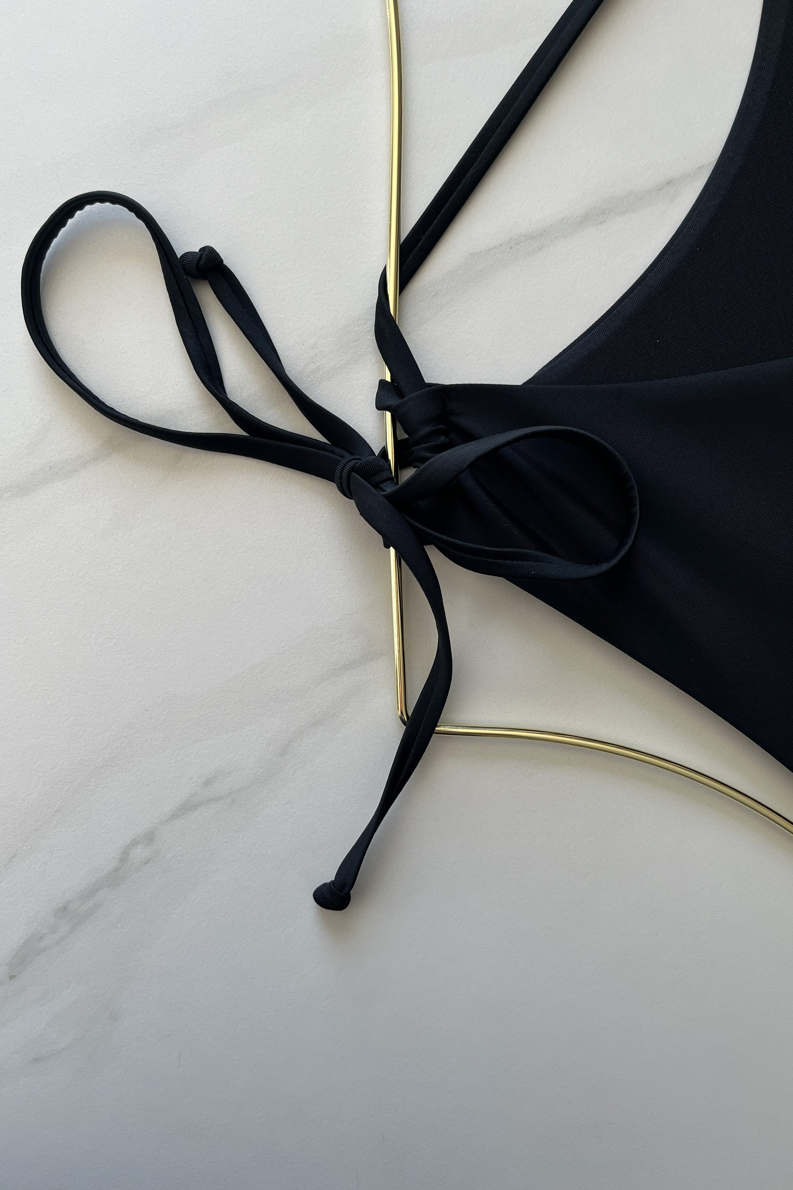 ESAMY The Vibe Cutout One-Piece Swimsuit in Black - Close-Up of Ring Detail and String Ties