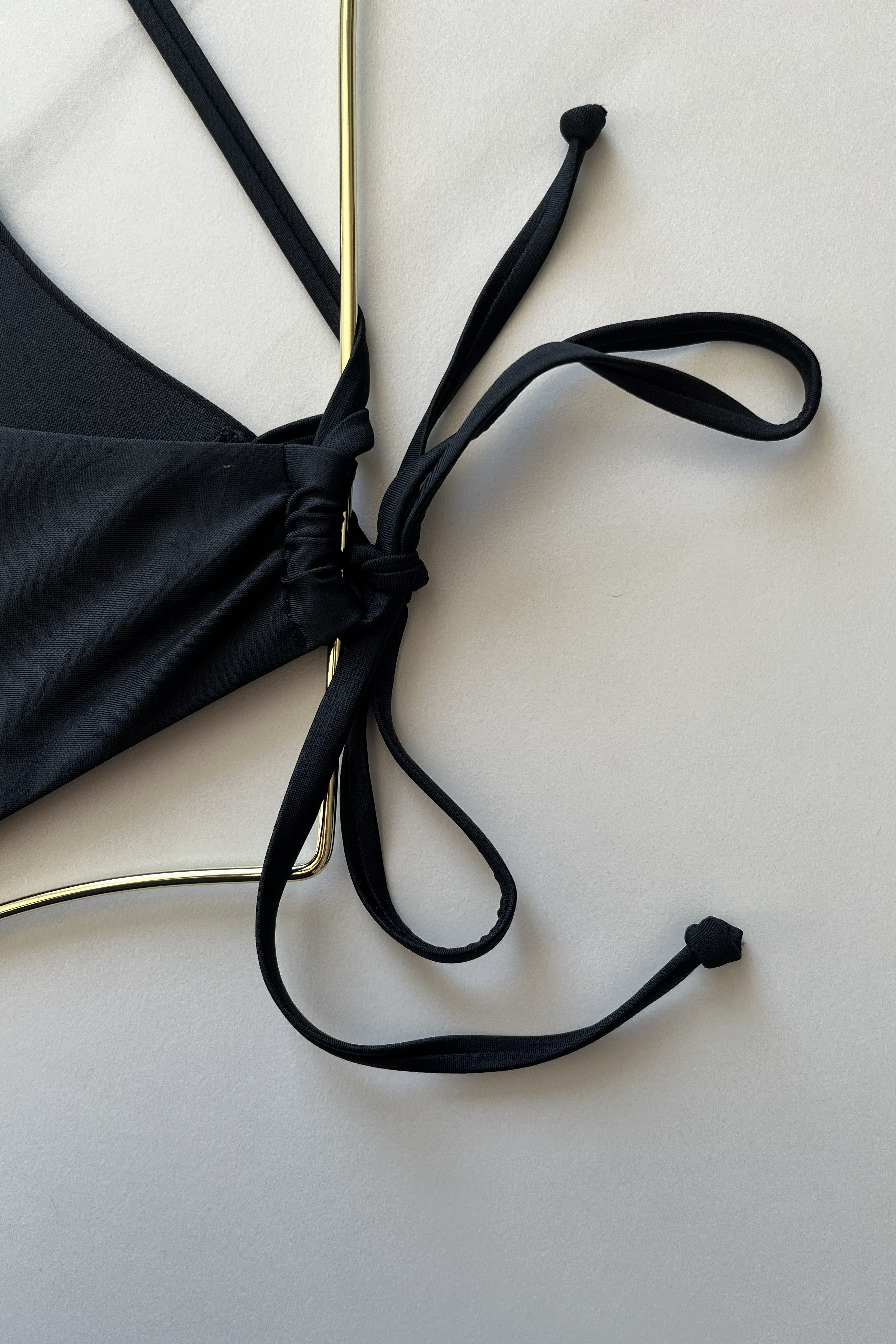 ESAMY The Sway Asymmetrical One-Piece Swimsuit in Black - Close-Up of Adjustable Back Clasp and String Ties