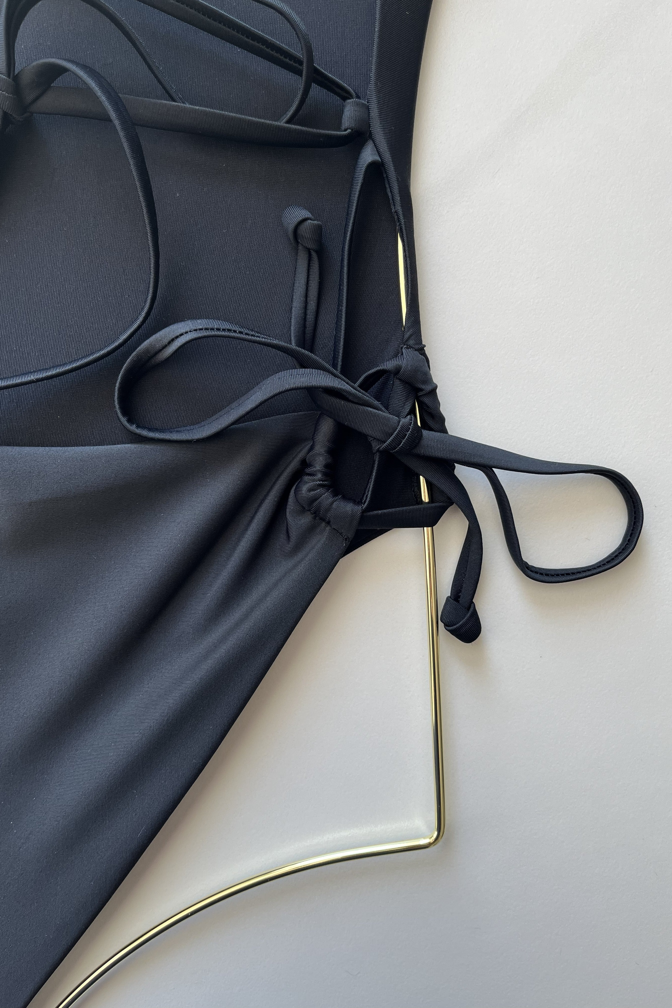 ESAMY The Twist Criss-Cross One-Piece Swimsuit in Black - Close-Up of Dig-Free Side String Ties